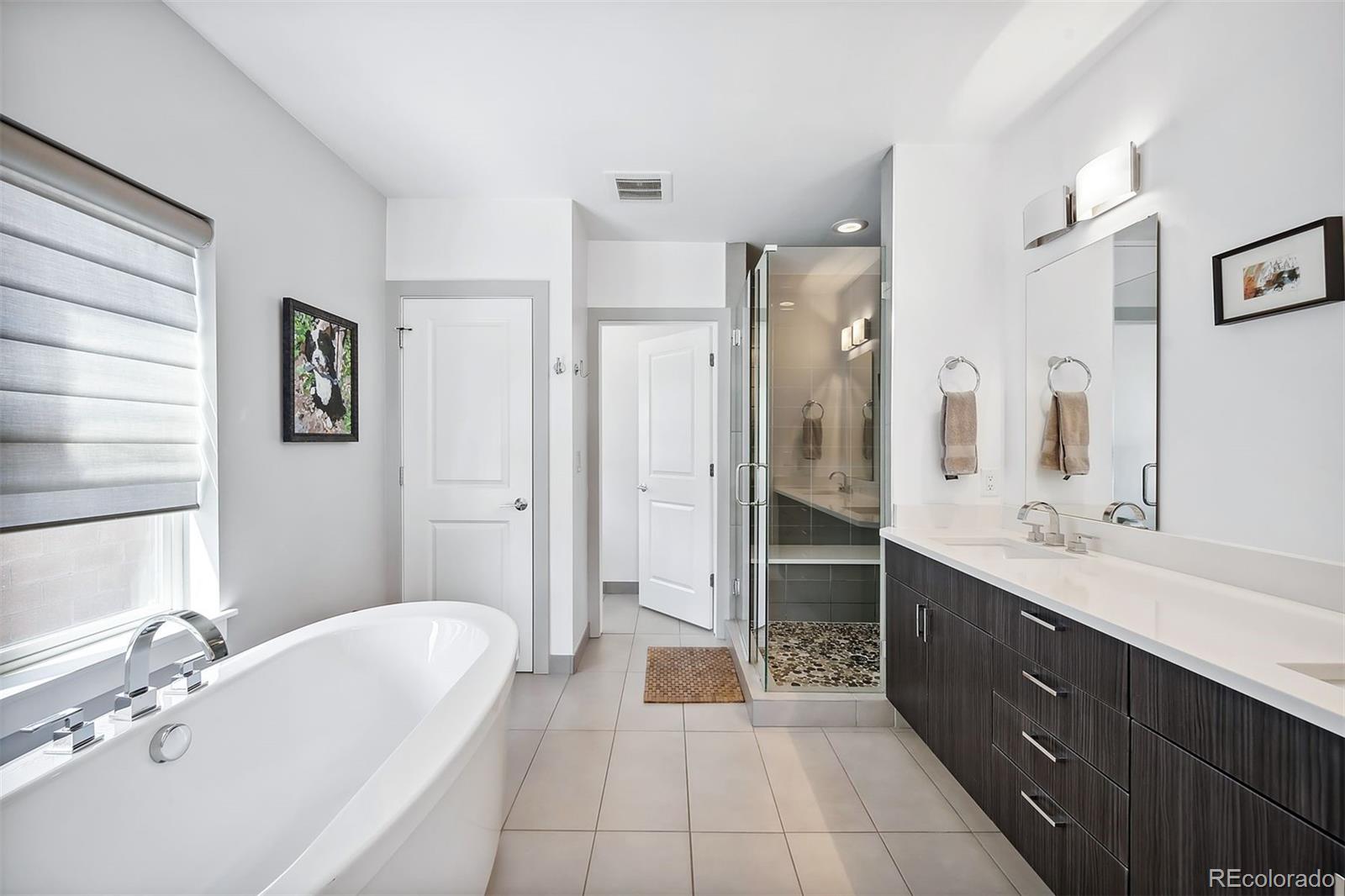 3536 Tejon Street Denver, CO 80211 - Photo 15 of 33 a spacious bathroom with a double vanity sink a mirror and a shower