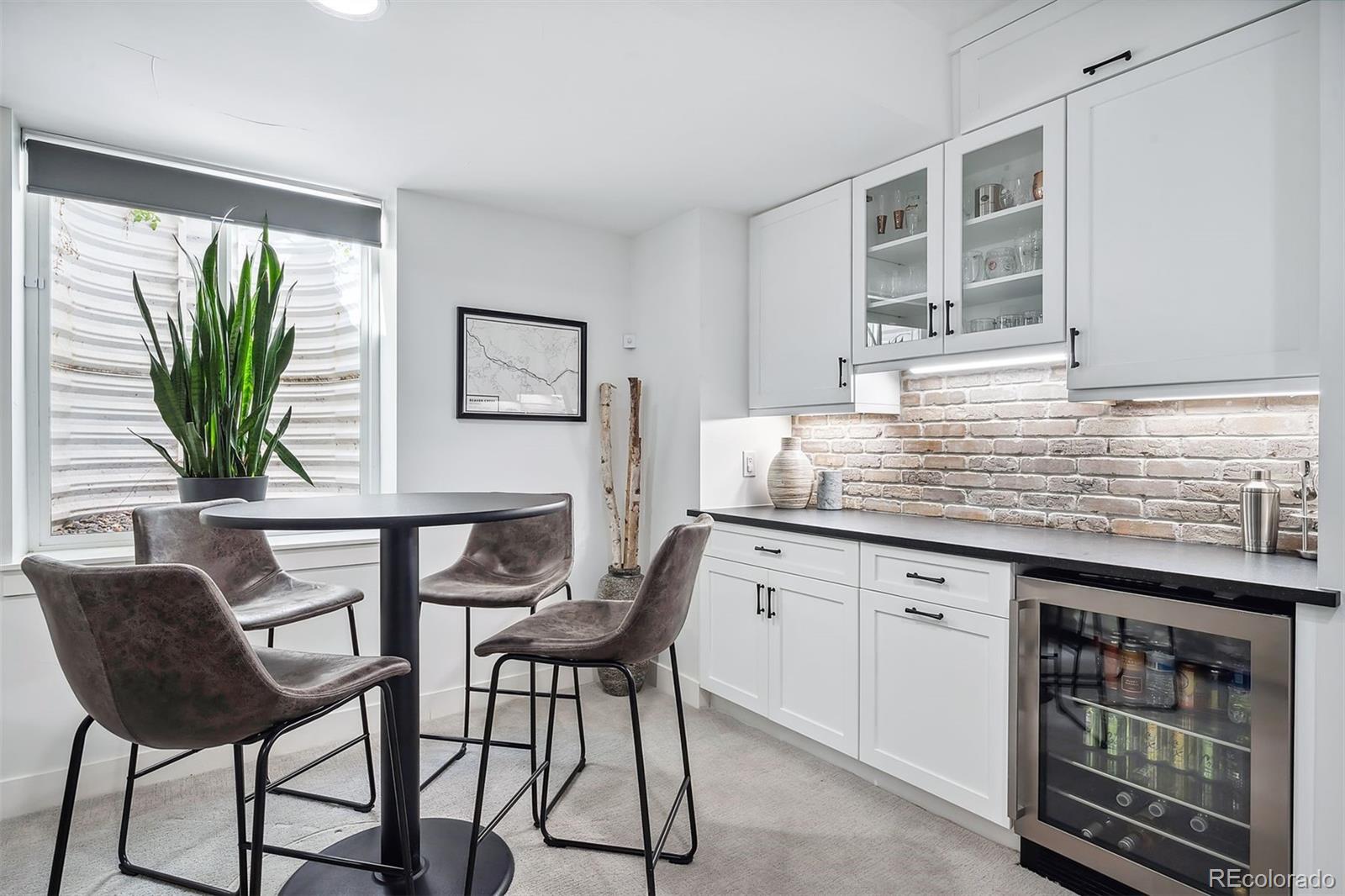 3536 Tejon Street Denver, CO 80211 - Photo 22 of 33 a kitchen with a table chairs and wooden floor