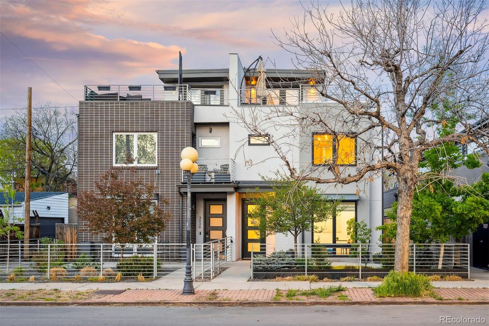 3536 Tejon Street Denver, CO 80211 - Photo 32 of 33 a front view of a building with glass windows and door