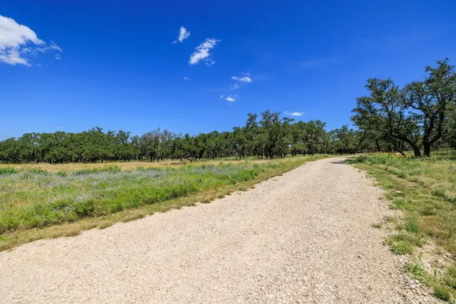 a view of a lake and green valley