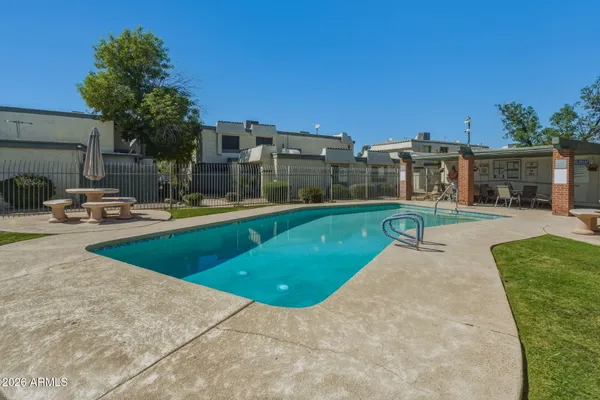 a swimming pool with outdoor seating and yard