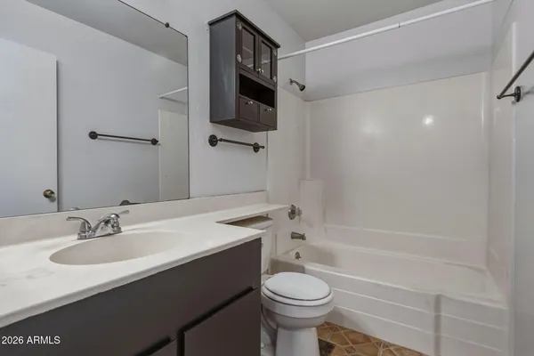 a bathroom with a sink toilet a mirror and shower