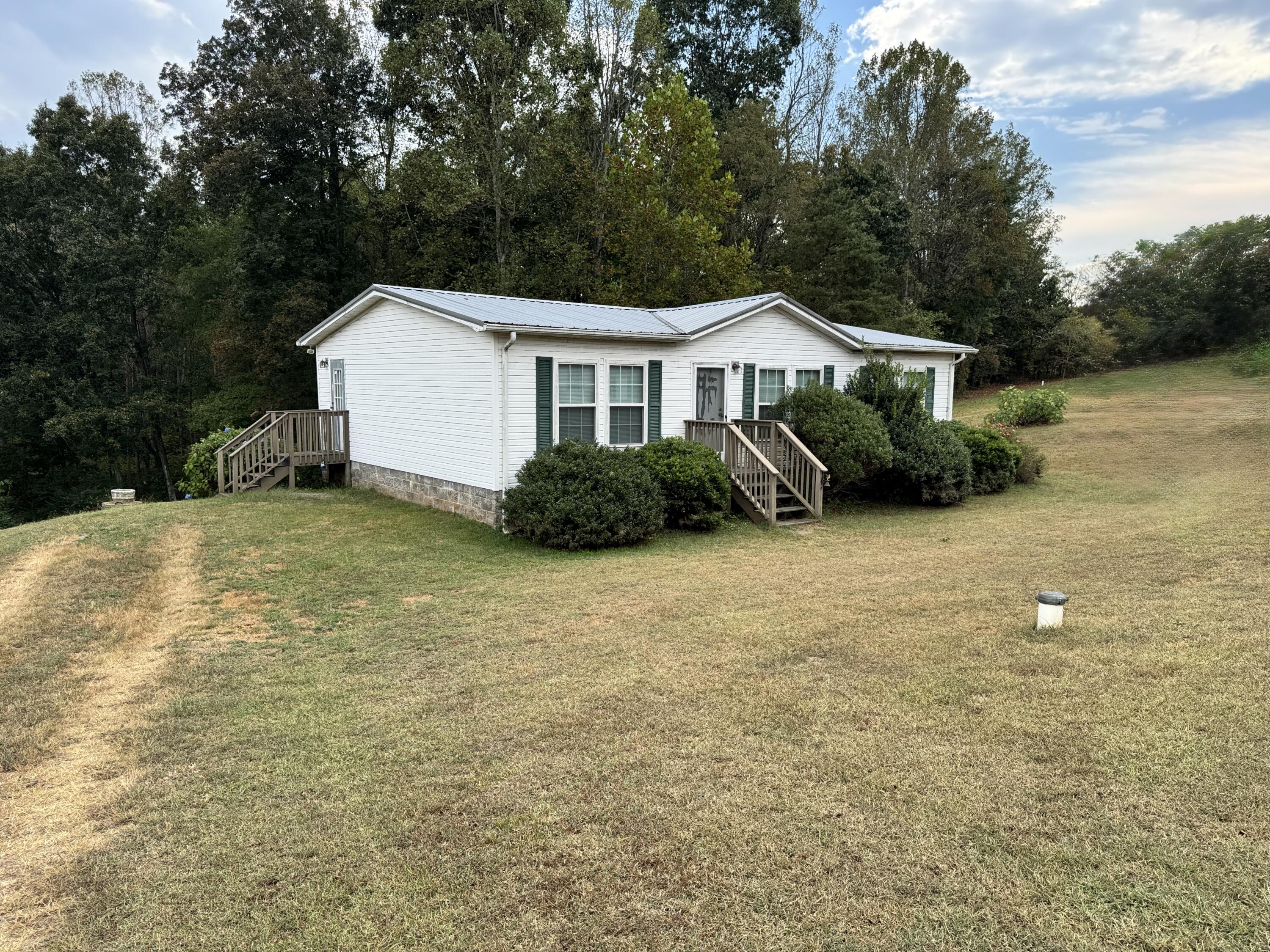 480 Glade Creek Road Glade Hill, VA 24092 - Photo 2 of 14 a view of a house with backyard and garden