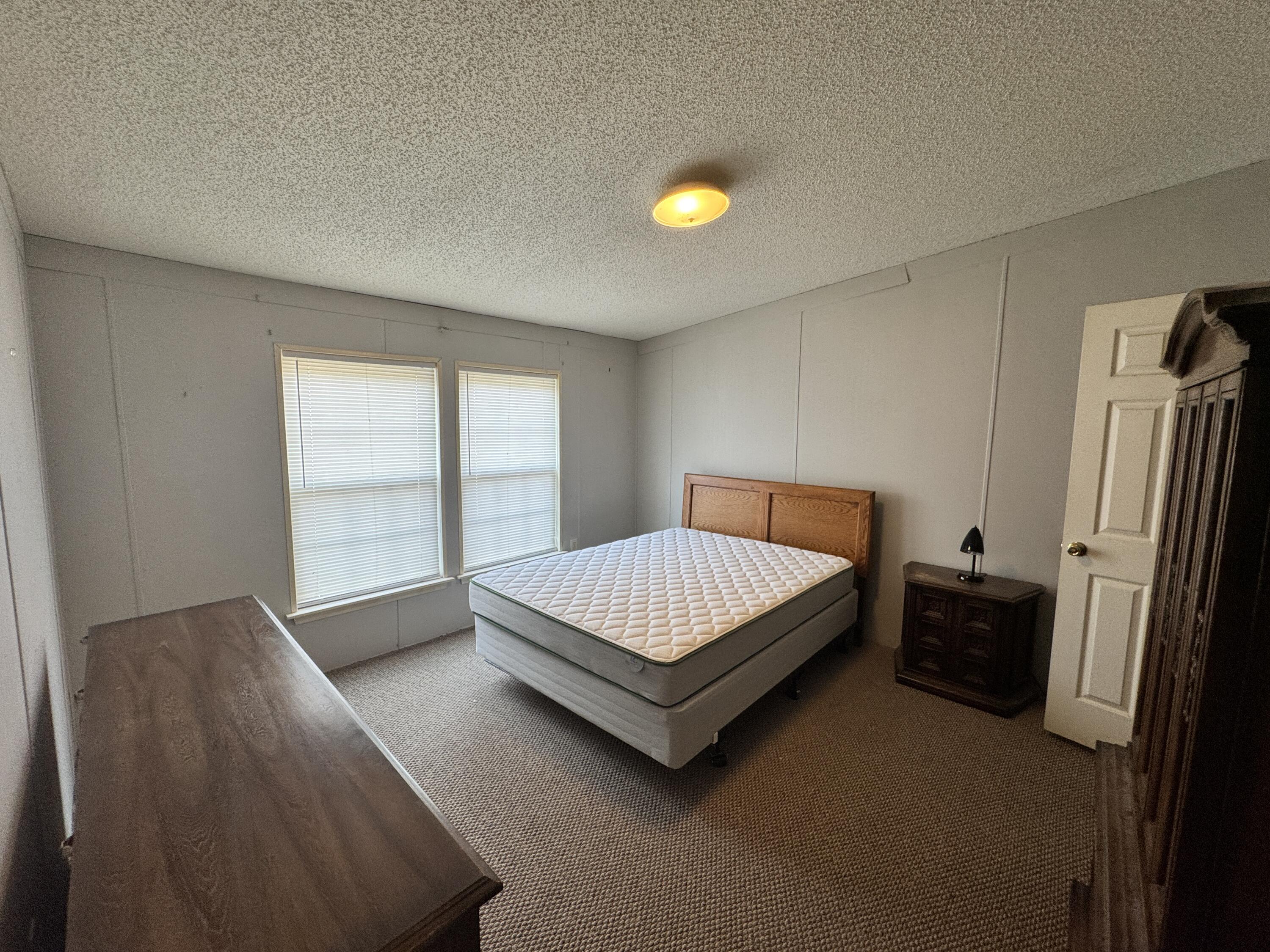 480 Glade Creek Road Glade Hill, VA 24092 - Photo 6 of 14 a bed sitting in a room next to a window