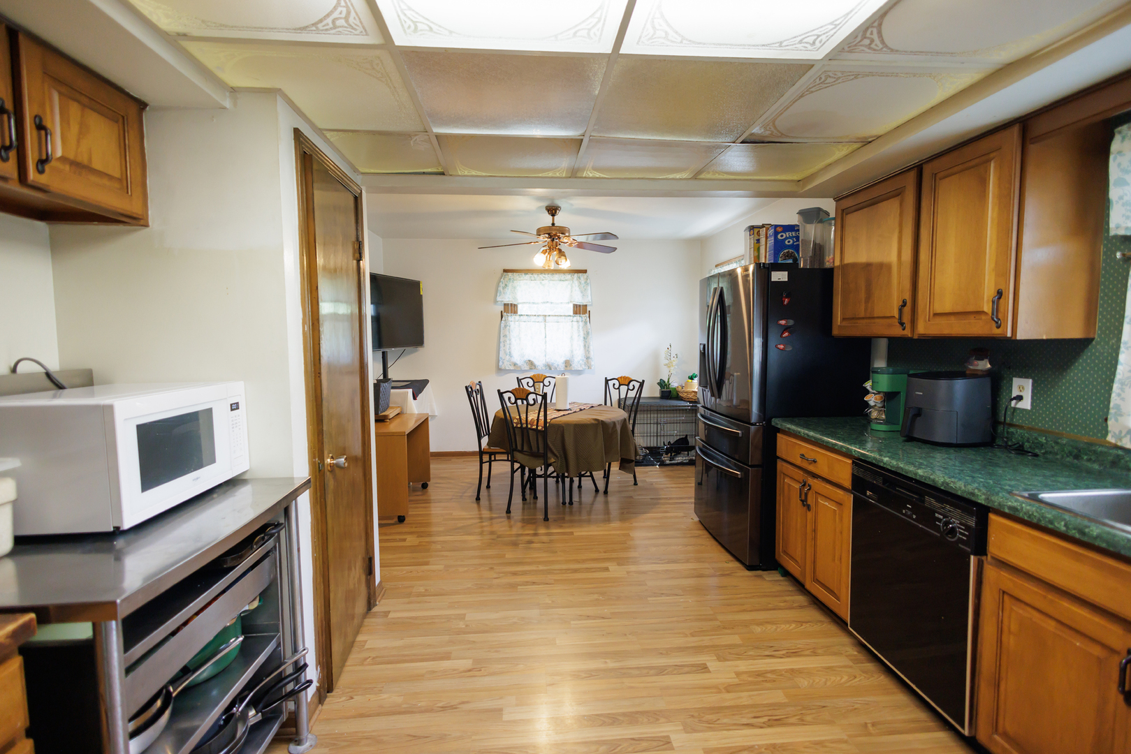 824 South McKinley Avenue Kankakee, IL 60901 - Photo 17 of 58 a kitchen with stainless steel appliances granite countertop a refrigerator a stove top oven a sink dishwasher and dining table with wooden floor