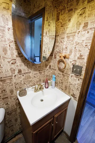 a bathroom with a sink mirror vanity and toilet