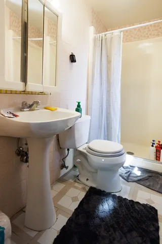 a white bath tub sitting next to a white toilet and sink