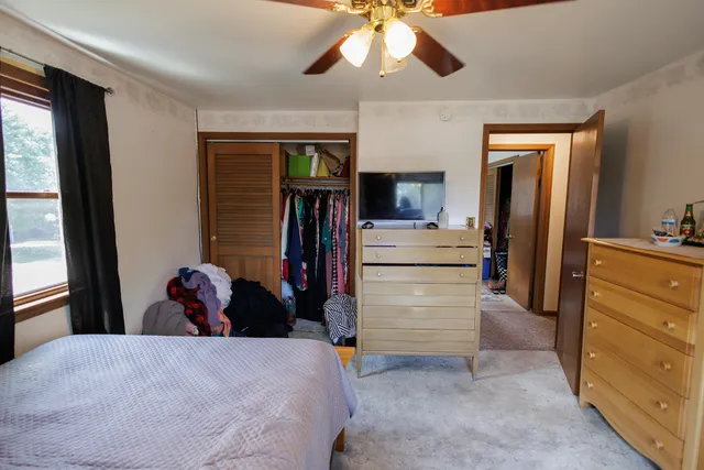 a bedroom with a bed and a window