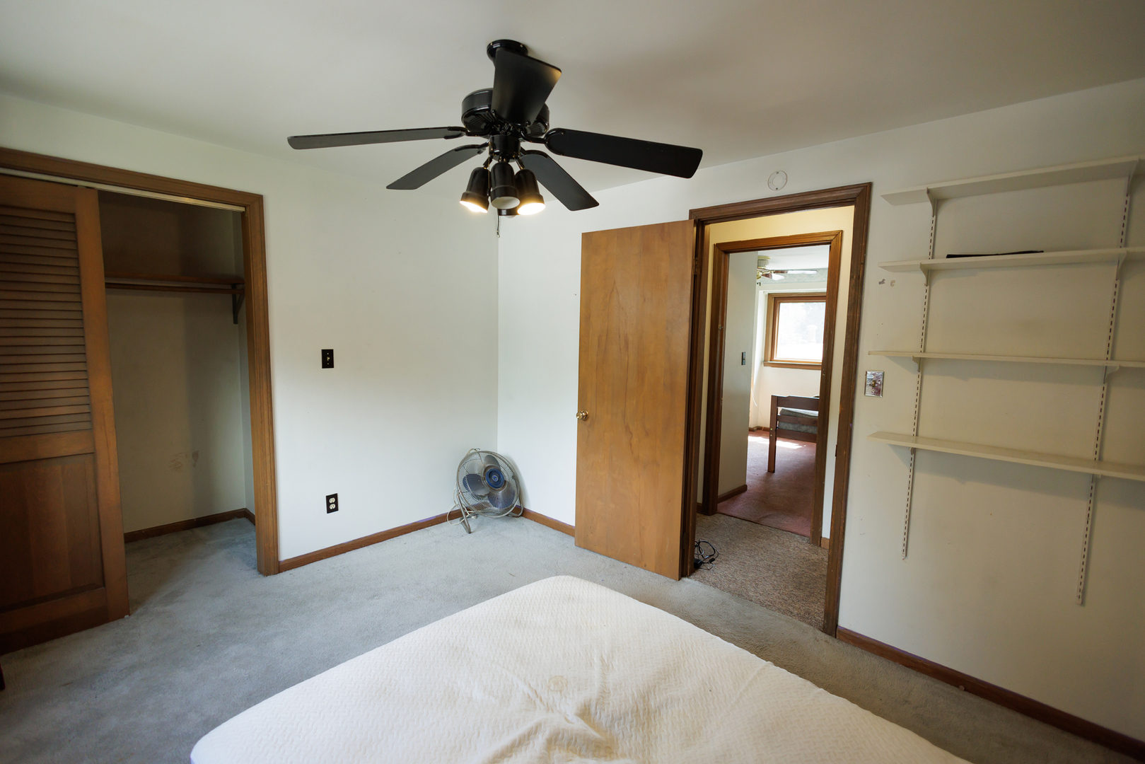 824 South McKinley Avenue Kankakee, IL 60901 - Photo 28 of 58 a bedroom with a bed and a chandelier