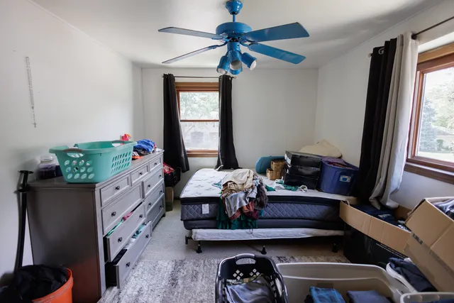 a bedroom with a bed and window