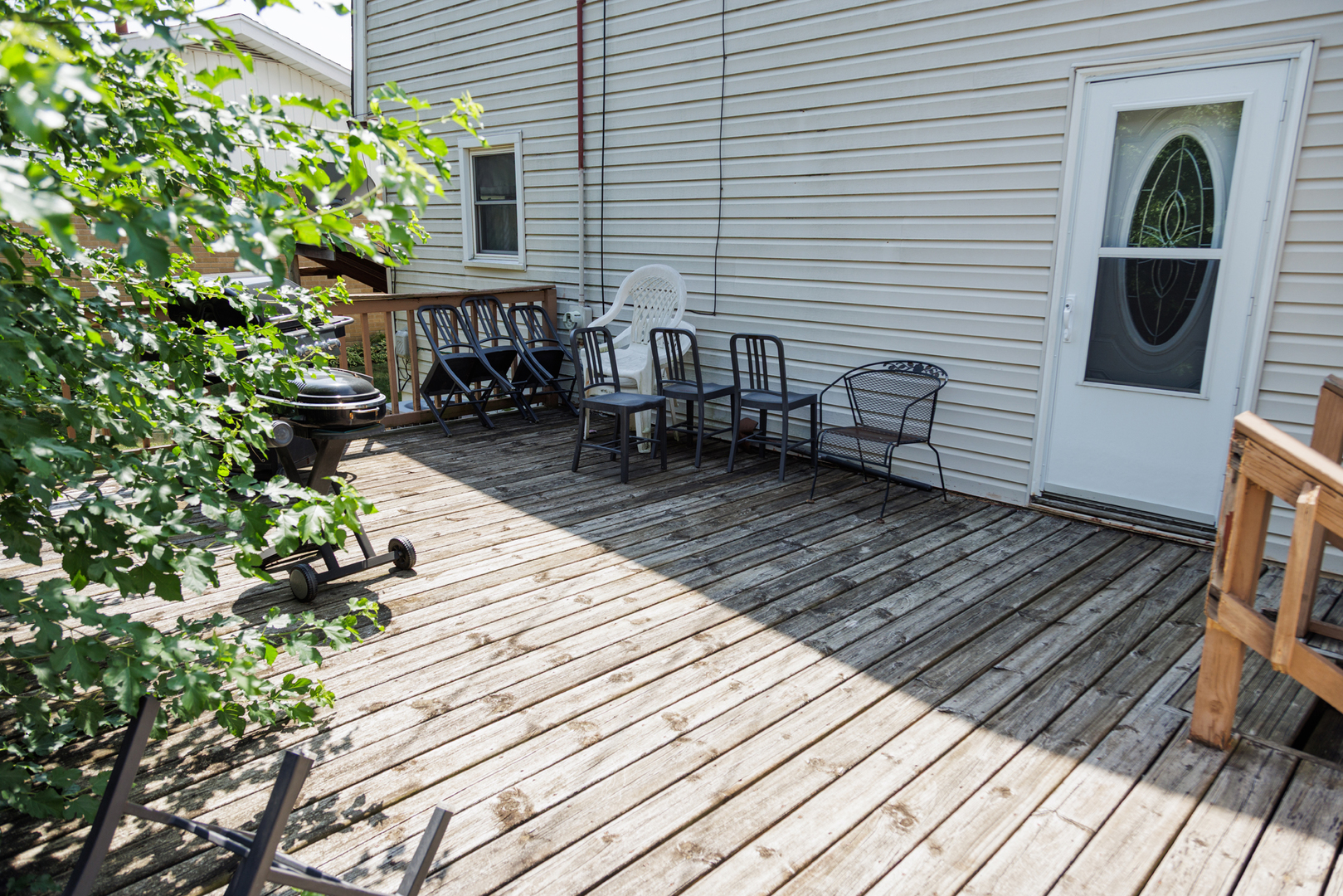 824 South McKinley Avenue Kankakee, IL 60901 - Photo 52 of 58 a view of a chairs and table on the wooden deck