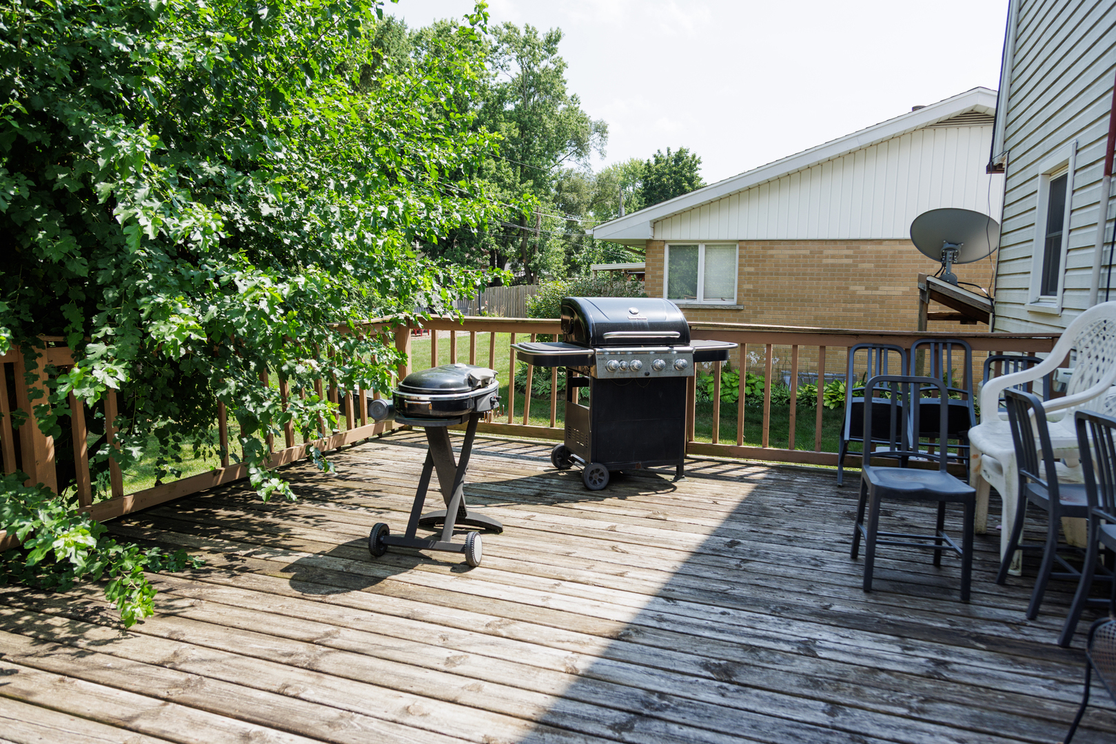 824 South McKinley Avenue Kankakee, IL 60901 - Photo 54 of 58 a view of a deck with table and chairs with wooden floor and fence