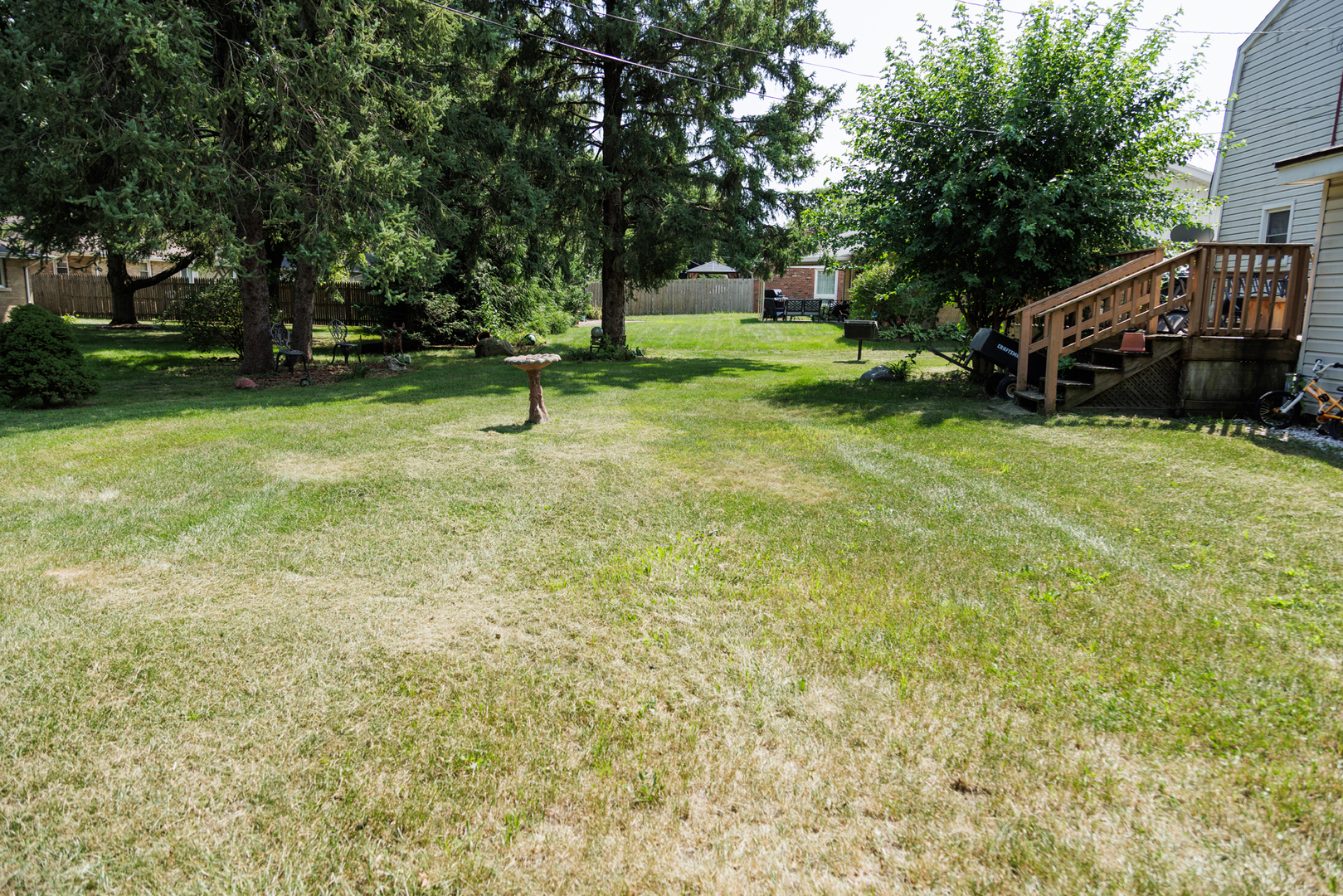 824 South McKinley Avenue Kankakee, IL 60901 - Photo 57 of 58 a backyard of a house with a bench and trees
