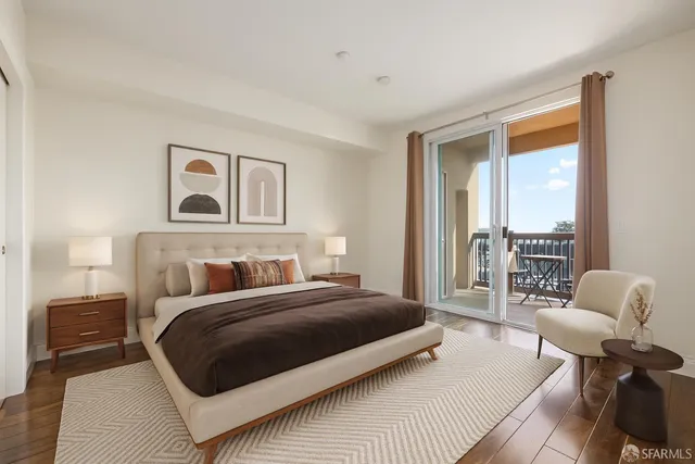 a bedroom with a bed and a couch next to a window