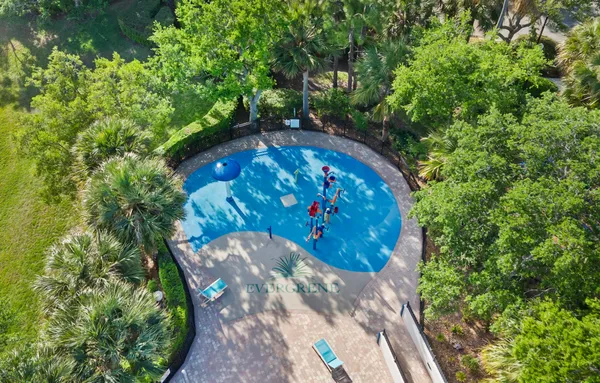 a view of a swimming pool with a yard