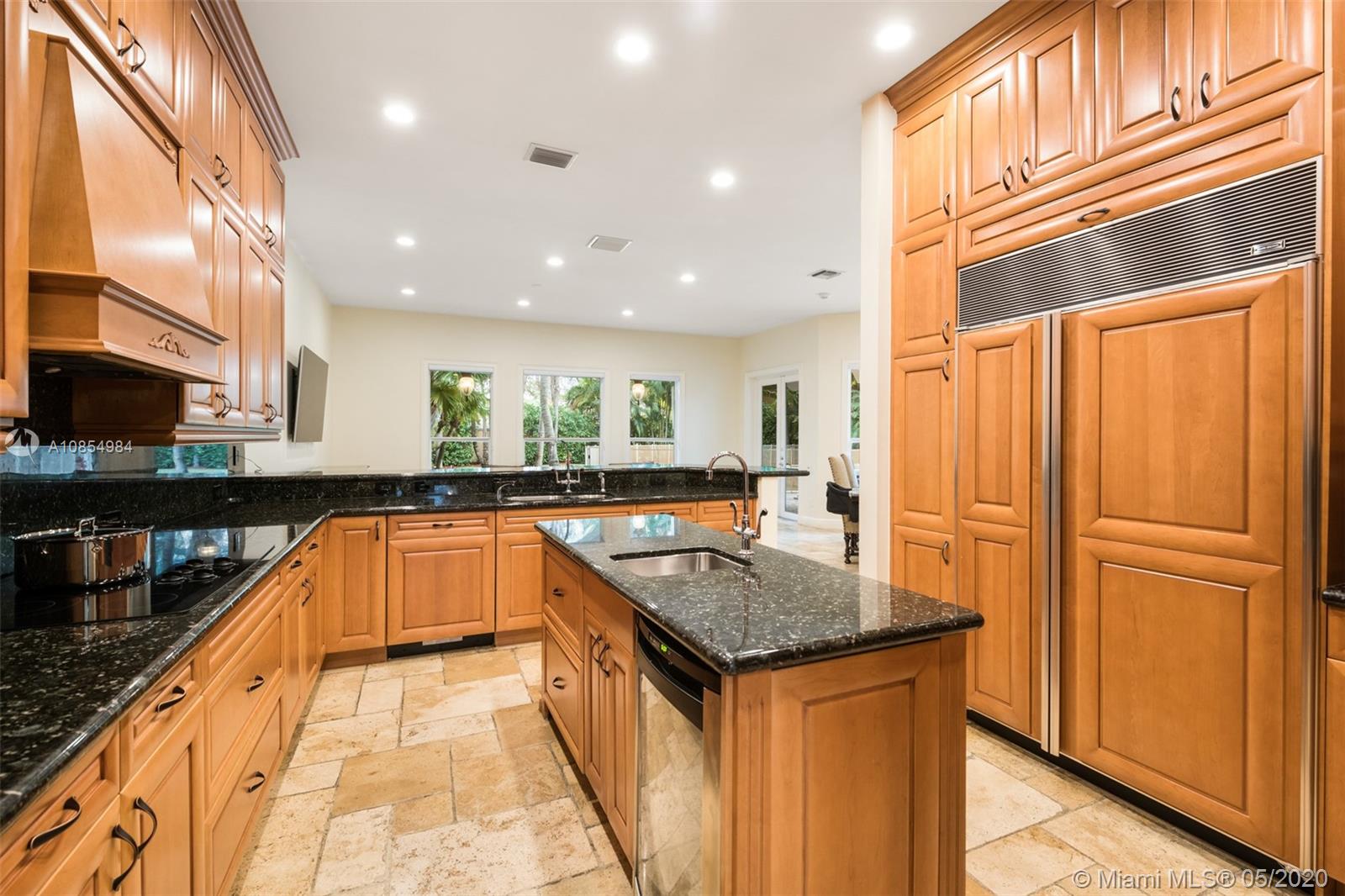 1475 Commodore Way Hollywood, FL 33019 - Photo 12 of 49 a kitchen with granite countertop a refrigerator and a sink