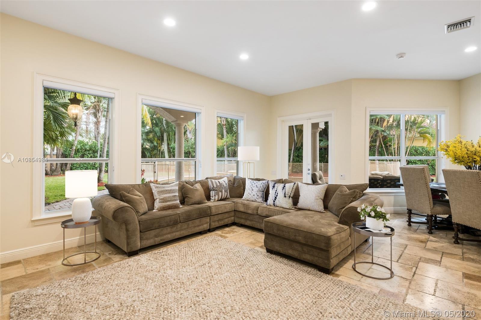 1475 Commodore Way Hollywood, FL 33019 - Photo 13 of 49 a living room with furniture and a large window