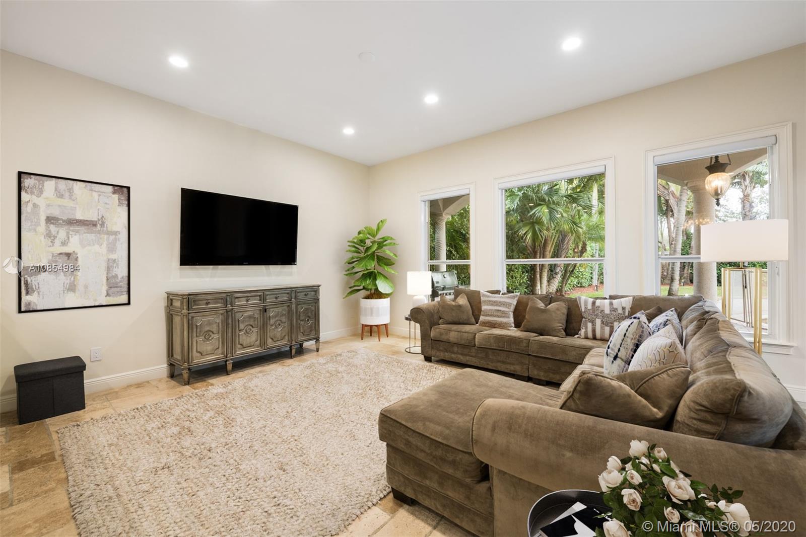 1475 Commodore Way Hollywood, FL 33019 - Photo 14 of 49 a living room with furniture a flat screen tv and a large window