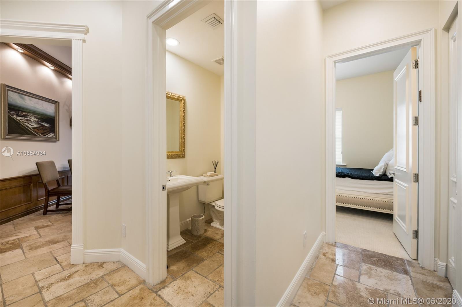 1475 Commodore Way Hollywood, FL 33019 - Photo 16 of 49 a en suite bathroom with a toilet sink and mirror