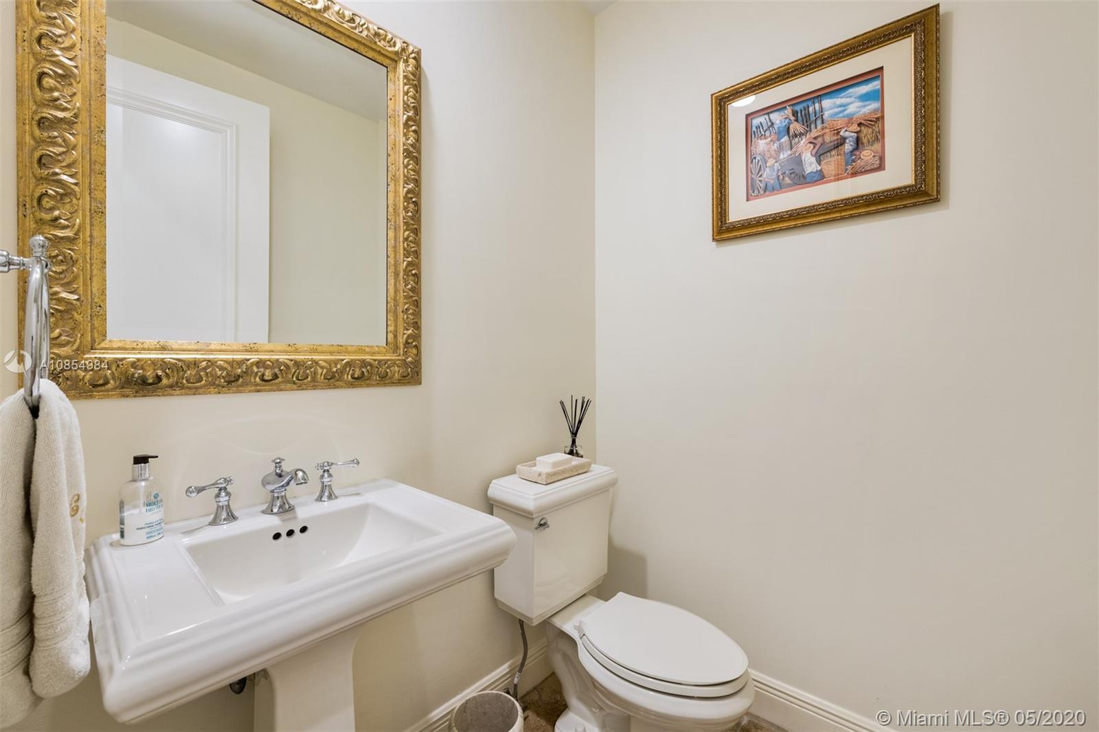 1475 Commodore Way Hollywood, FL 33019 - Photo 17 of 49 a bathroom with a sink mirror and toilet