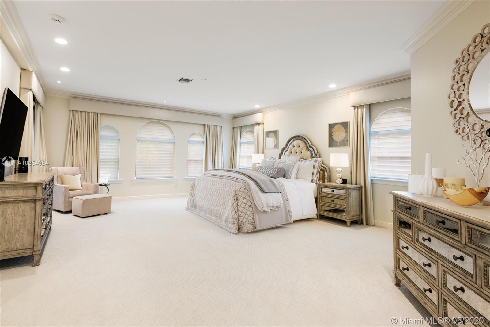 1475 Commodore Way Hollywood, FL 33019 - Photo 20 of 49 a spacious bedroom with a bed a couch and dresser