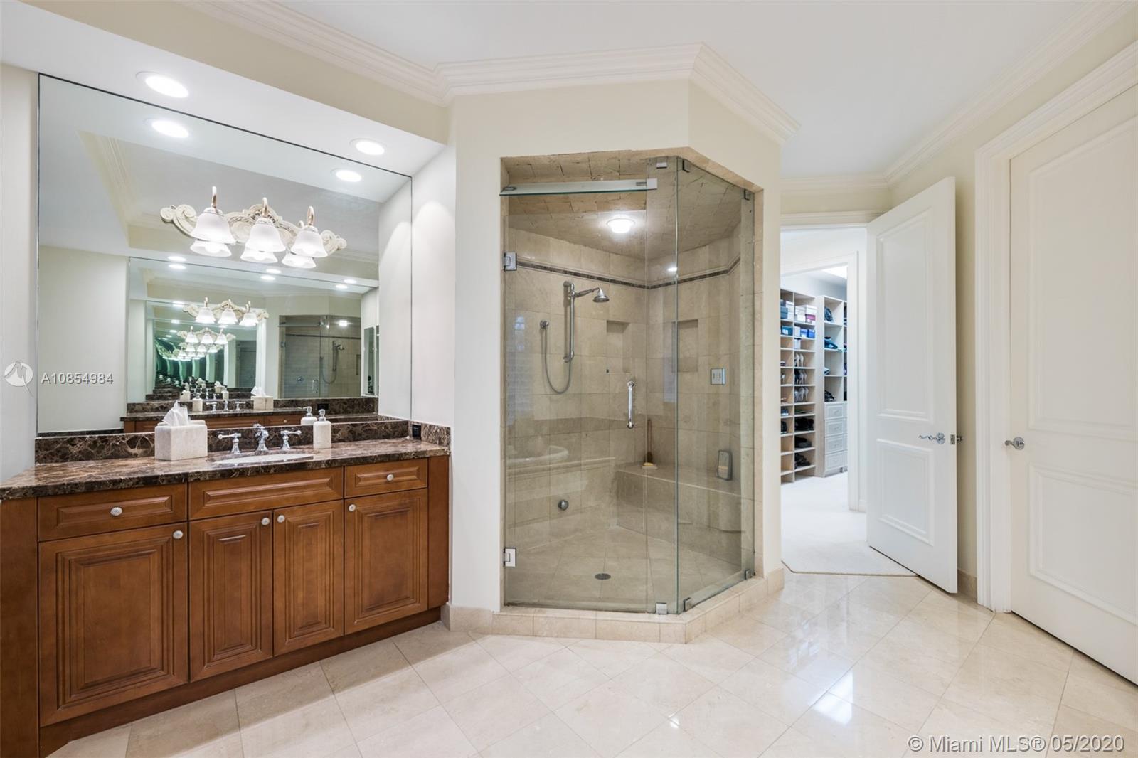 1475 Commodore Way Hollywood, FL 33019 - Photo 23 of 49 a bathroom with a glass shower door and a sink
