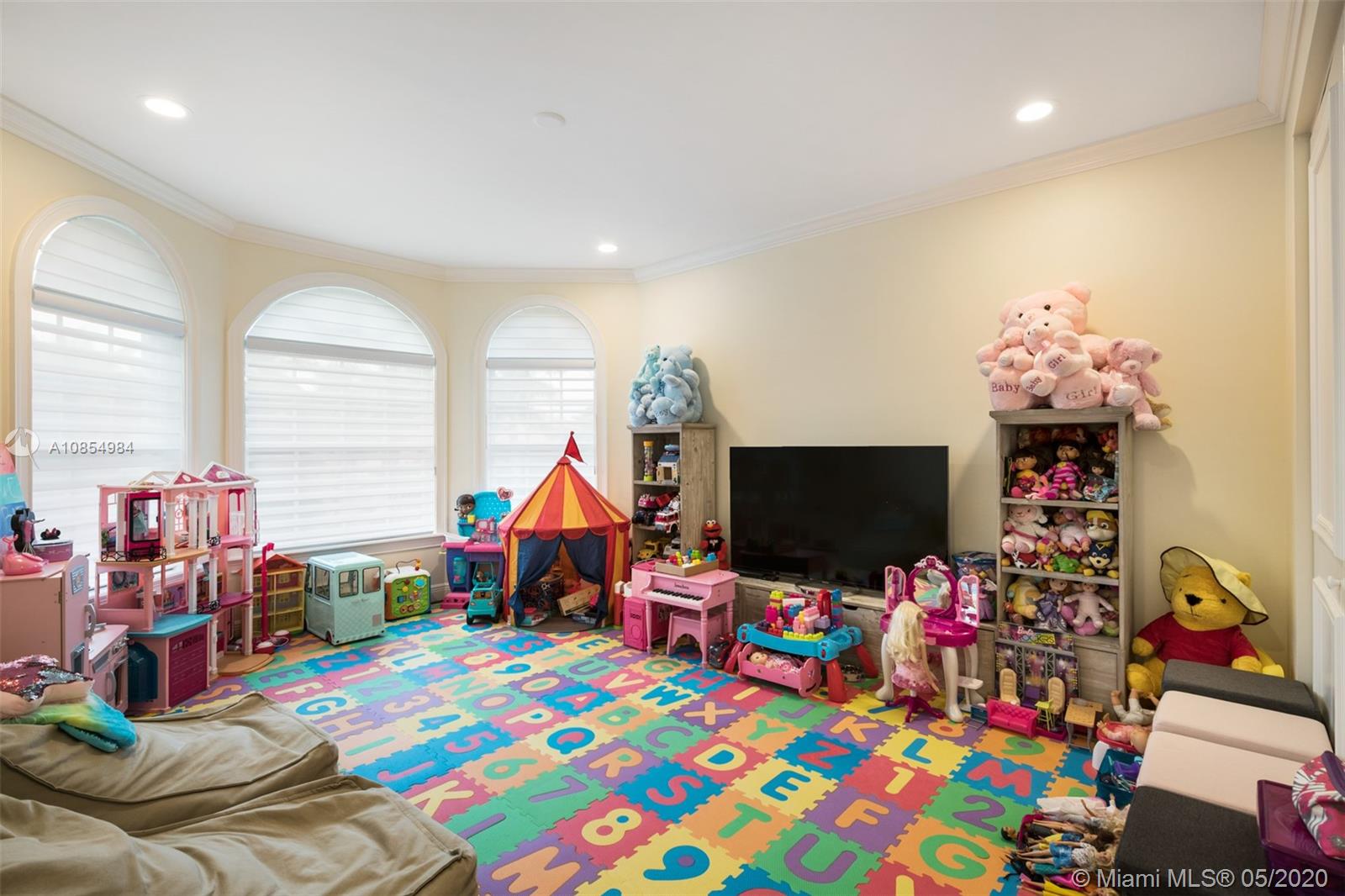 1475 Commodore Way Hollywood, FL 33019 - Photo 26 of 49 a children room with toys and a flat screen tv