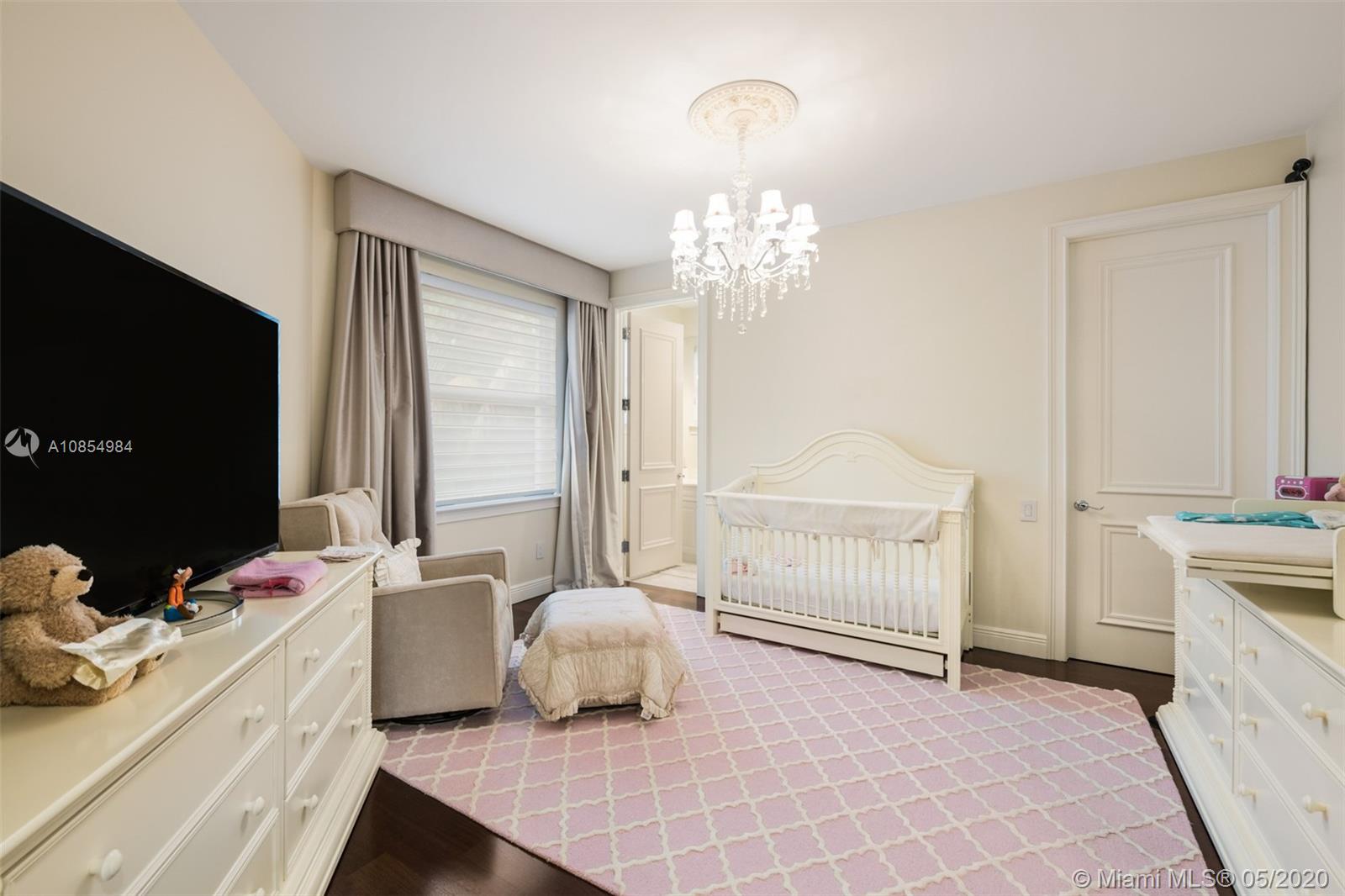 1475 Commodore Way Hollywood, FL 33019 - Photo 27 of 49 a spacious bedroom with a bed and a flat screen tv