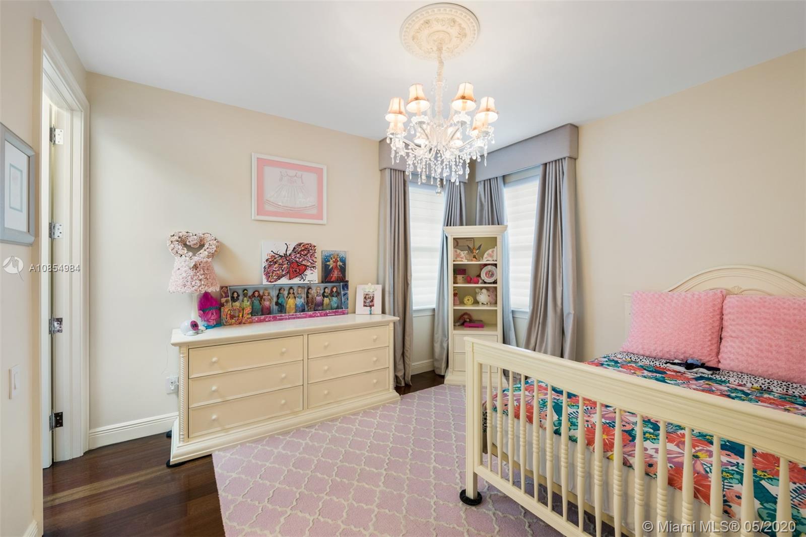 1475 Commodore Way Hollywood, FL 33019 - Photo 28 of 49 a bedroom with furniture and a baby crib