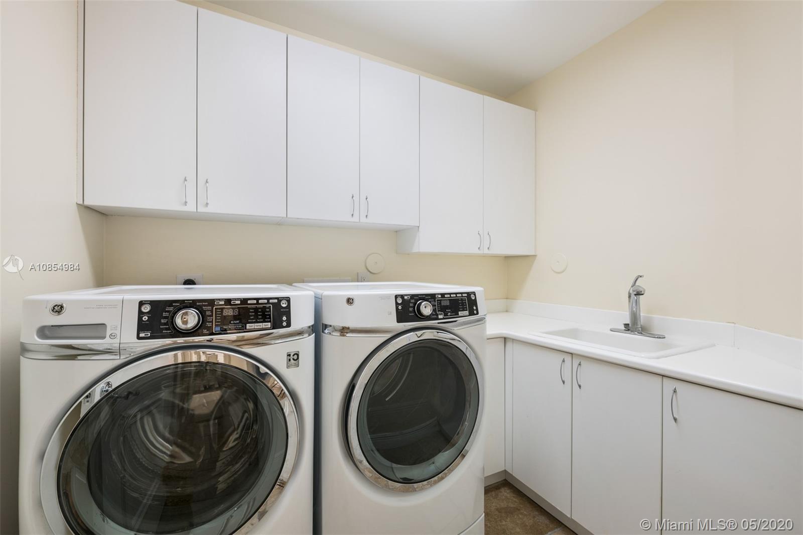 1475 Commodore Way Hollywood, FL 33019 - Photo 30 of 49 a utility room with sink dryer and washer