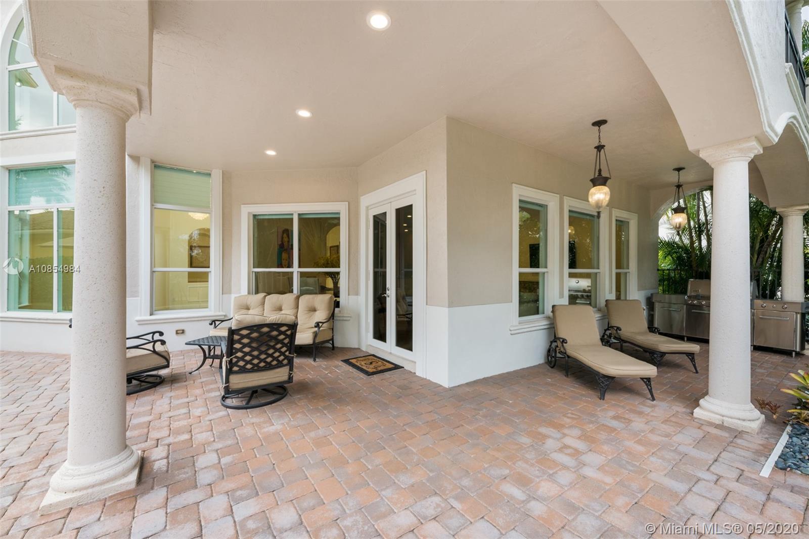 1475 Commodore Way Hollywood, FL 33019 - Photo 34 of 49 a building outdoor space with patio furniture and potted plants