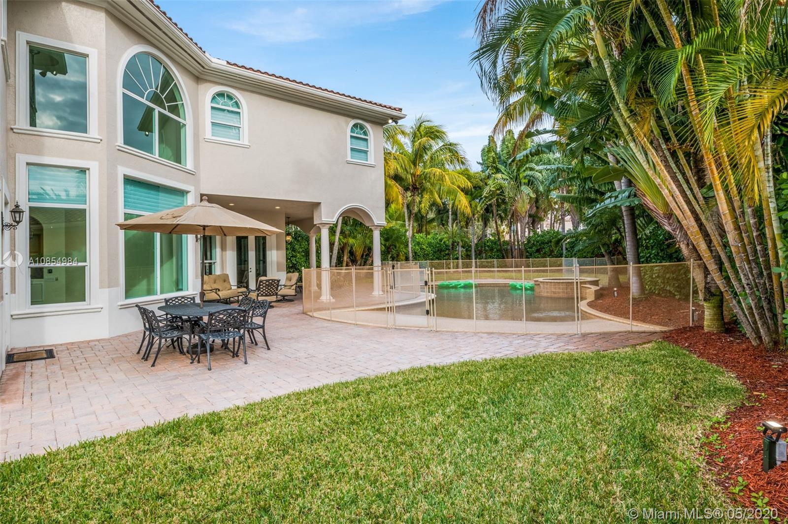 1475 Commodore Way Hollywood, FL 33019 - Photo 37 of 49 a view of a house with a backyard and a patio