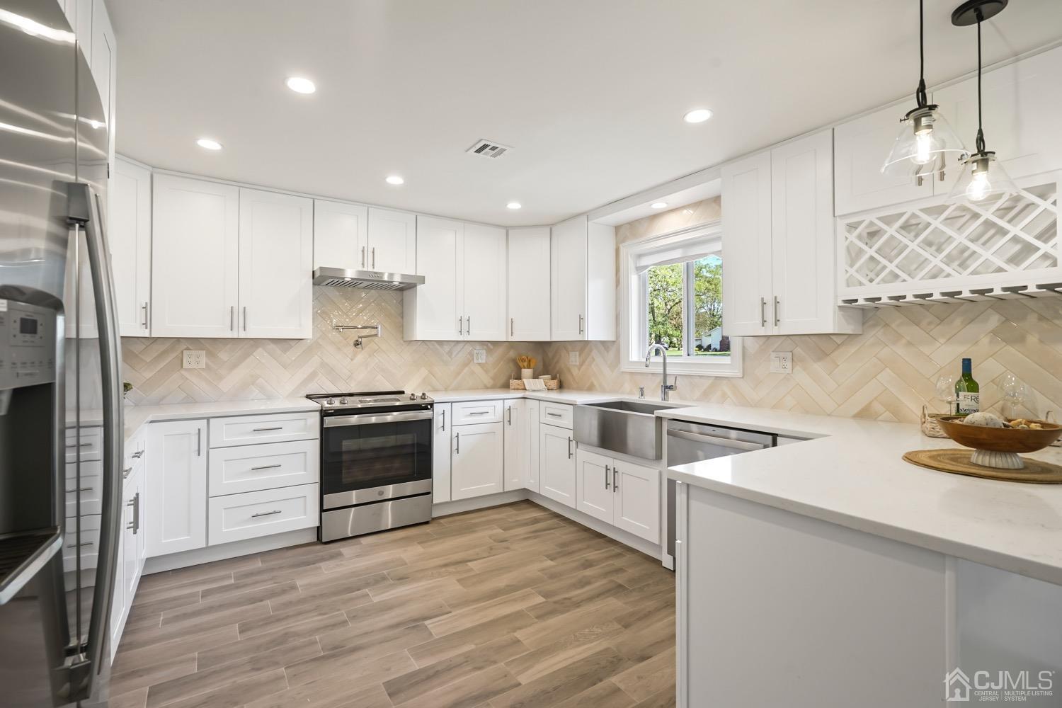 a kitchen with a white stove top oven and white cabinets