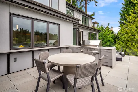 a view of a patio with lawn chairs and a yard