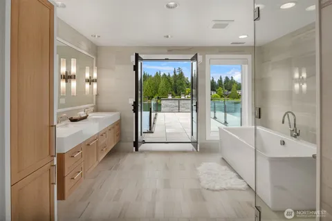 a white bath tub sitting next to a shower