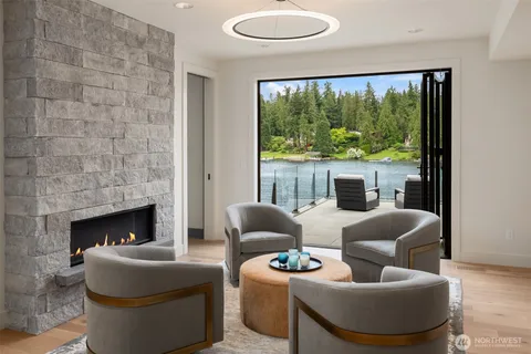 a living room with furniture a fireplace and a large window