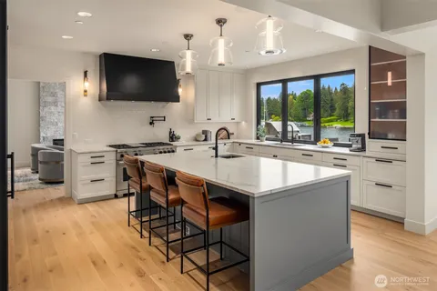 a kitchen with stainless steel appliances a microwave a sink and a stove