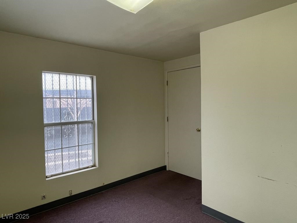3530 North Pecos Road Las Vegas, NV 89115 - Photo 30 of 46 Empty room with baseboards and dark carpet