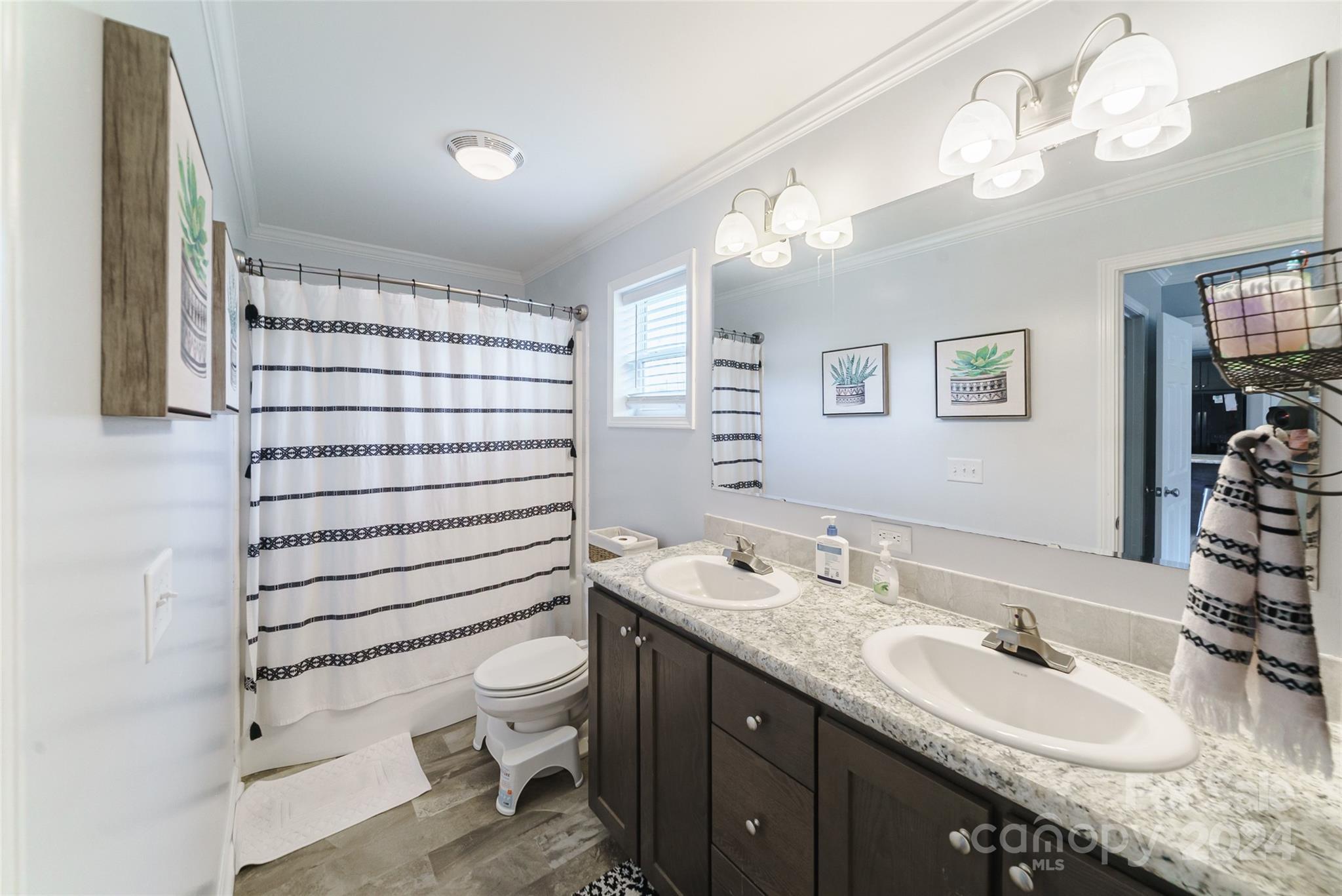9405 Smith Road Kannapolis, NC 28081 - Photo 23 of 35 a bathroom with a granite countertop double vanity sink mirror and toilet
