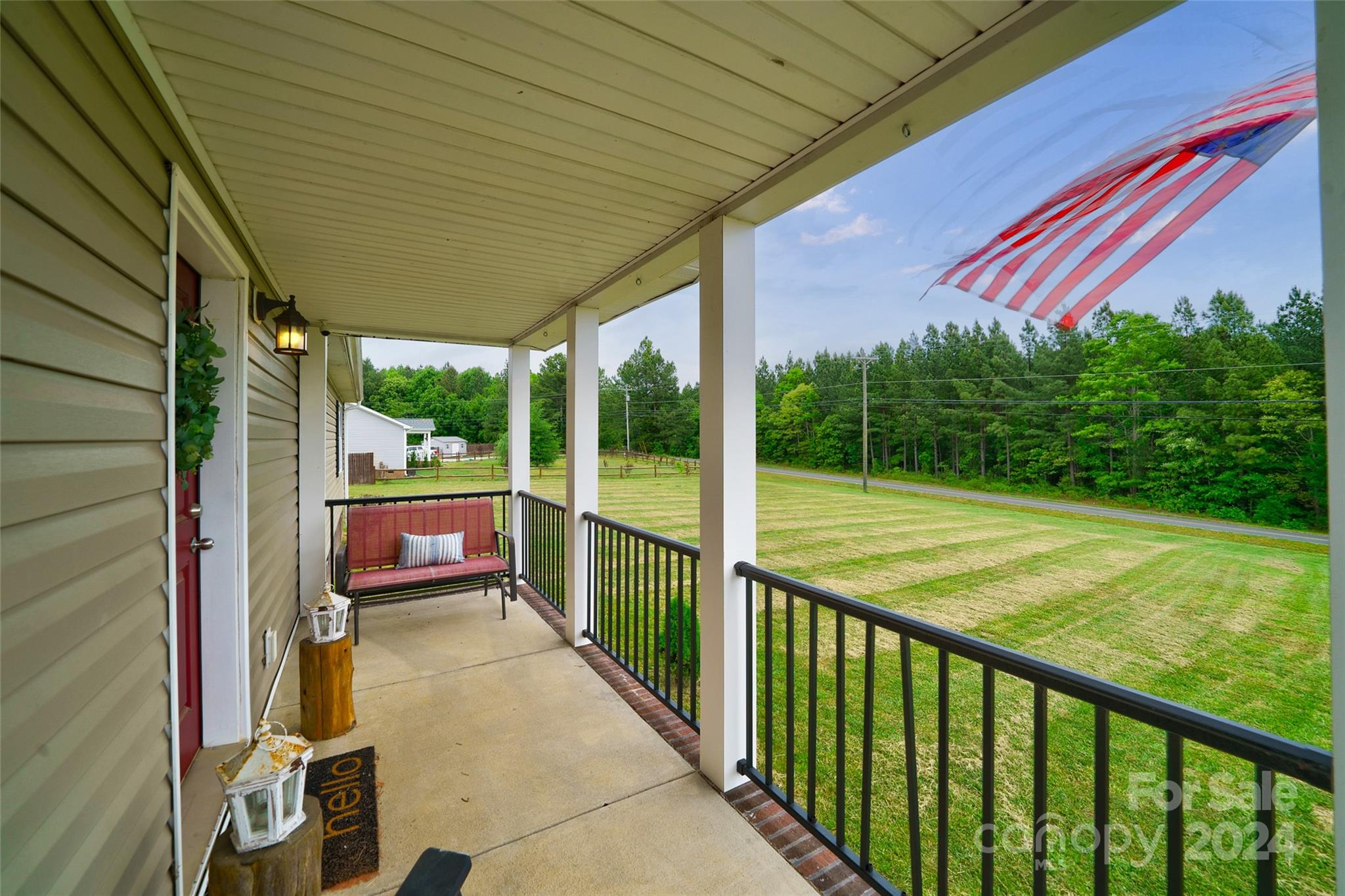 9405 Smith Road Kannapolis, NC 28081 - Photo 8 of 35 a view of a porch with wooden floor and roof