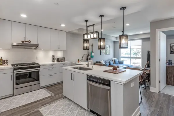 a kitchen with a sink stove and cabinets