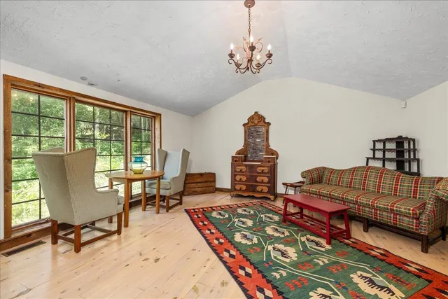 a living room with furniture a rug and a chandelier