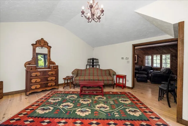 a bedroom with furniture and a wooden floor