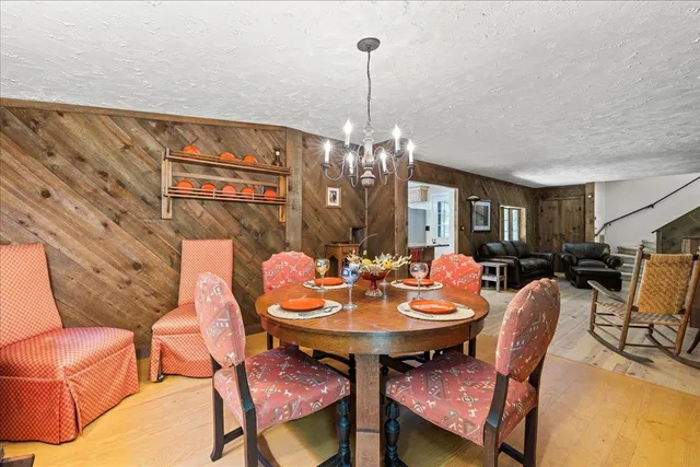 a view of a dining room with furniture and chandelier