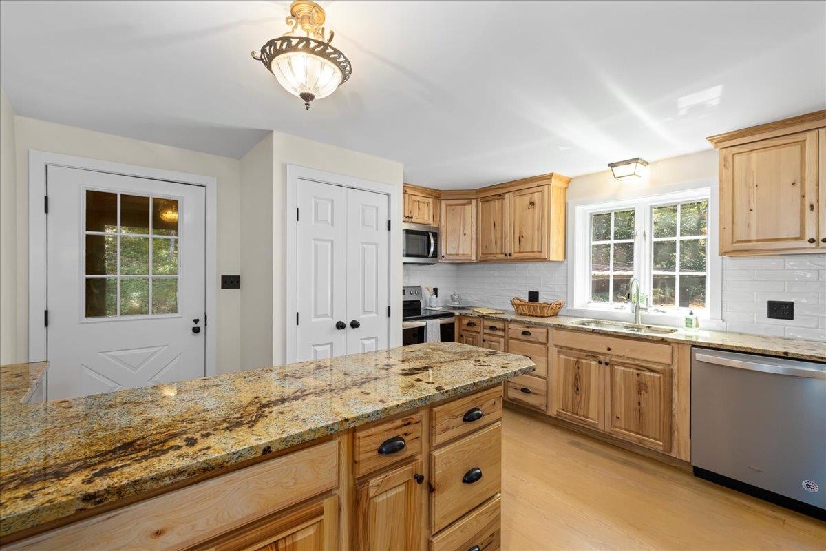 6614 Middlebrook Road Raphine, VA 24472 - Photo 22 of 52 a kitchen with granite countertop a sink stove and cabinets