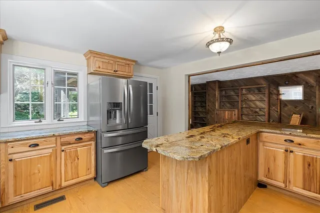 a kitchen with white cabinets and appliances
