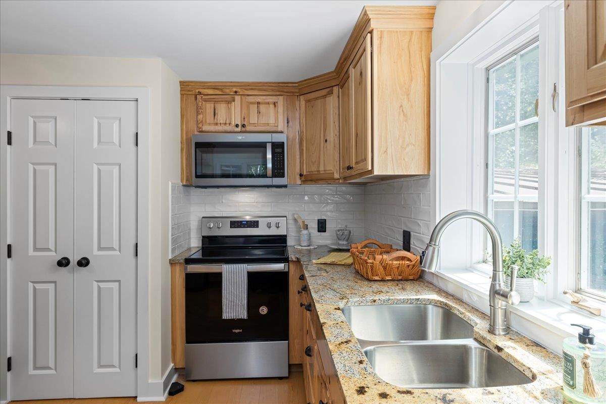 6614 Middlebrook Road Raphine, VA 24472 - Photo 26 of 52 a kitchen with granite countertop a stove a sink and a microwave