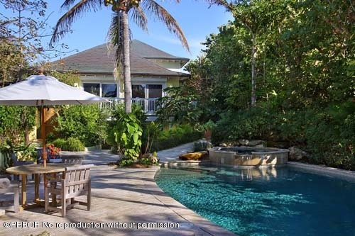 6195 North Ocean Boulevard Ocean Ridge, FL 33435 - Photo 3 of 12 a view of a patio with table and chairs under an umbrella