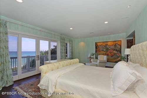 6195 North Ocean Boulevard Ocean Ridge, FL 33435 - Photo 9 of 12 a bedroom with a large bed and a large window