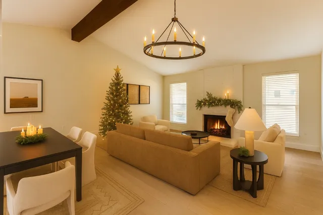 a living room with furniture a chandelier and a fireplace